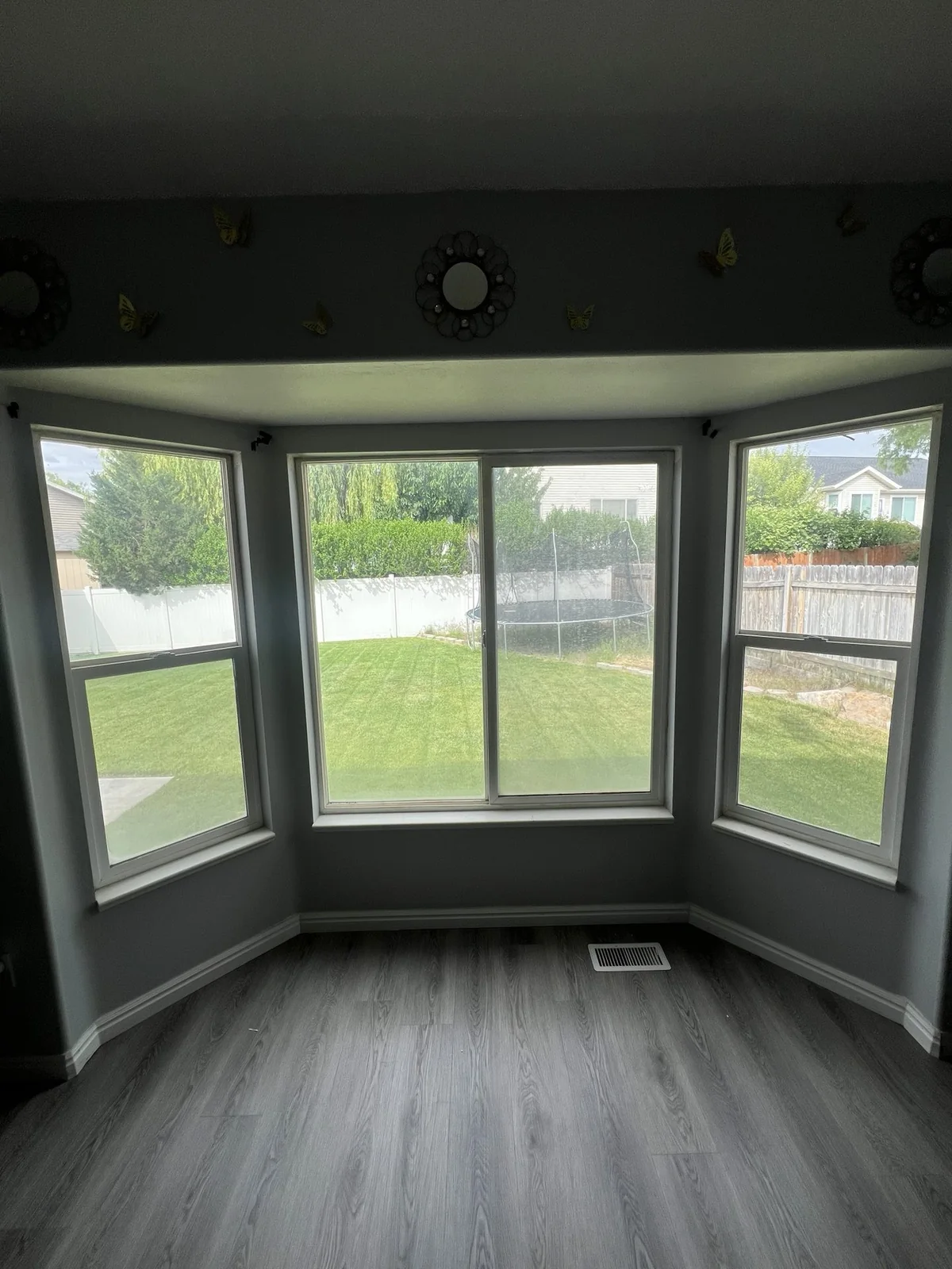 White bay windows viewed from an empty room