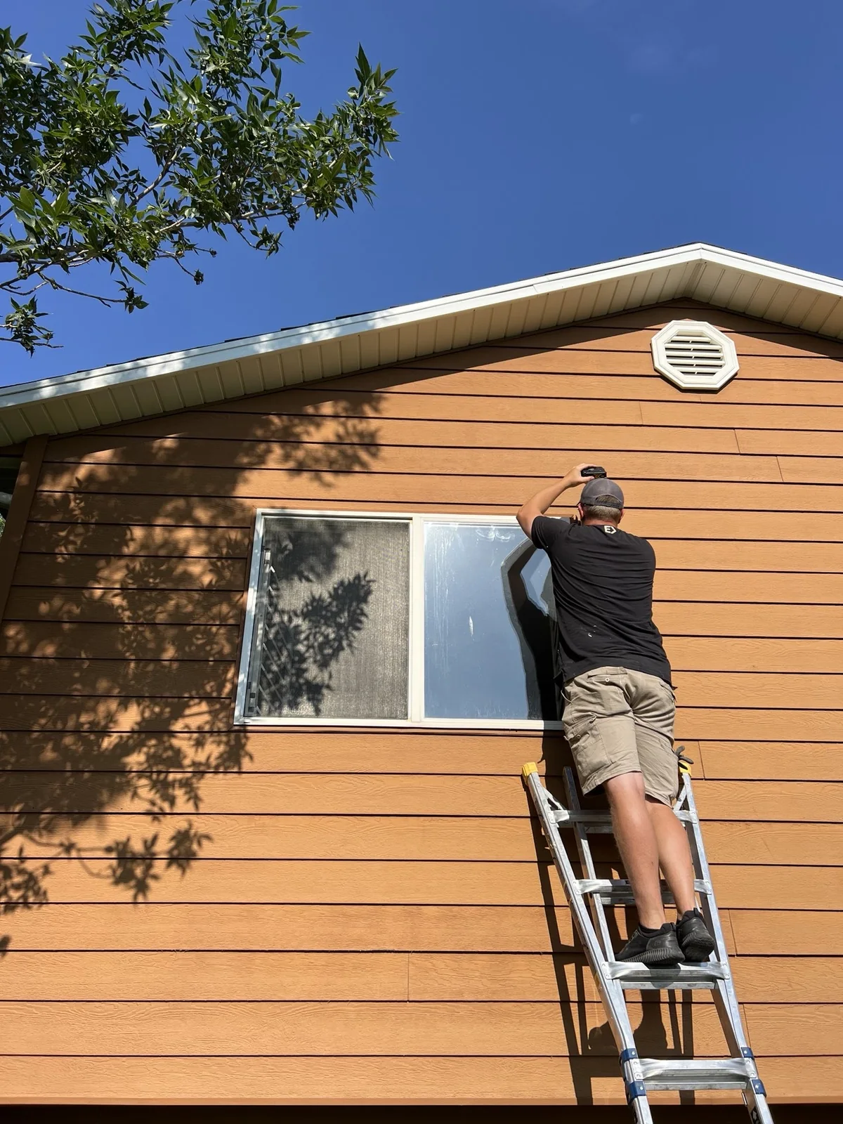Elite installer working above an exterior window