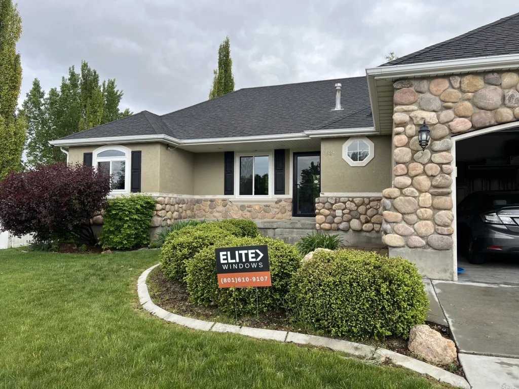 White windows on a stucco and stone home